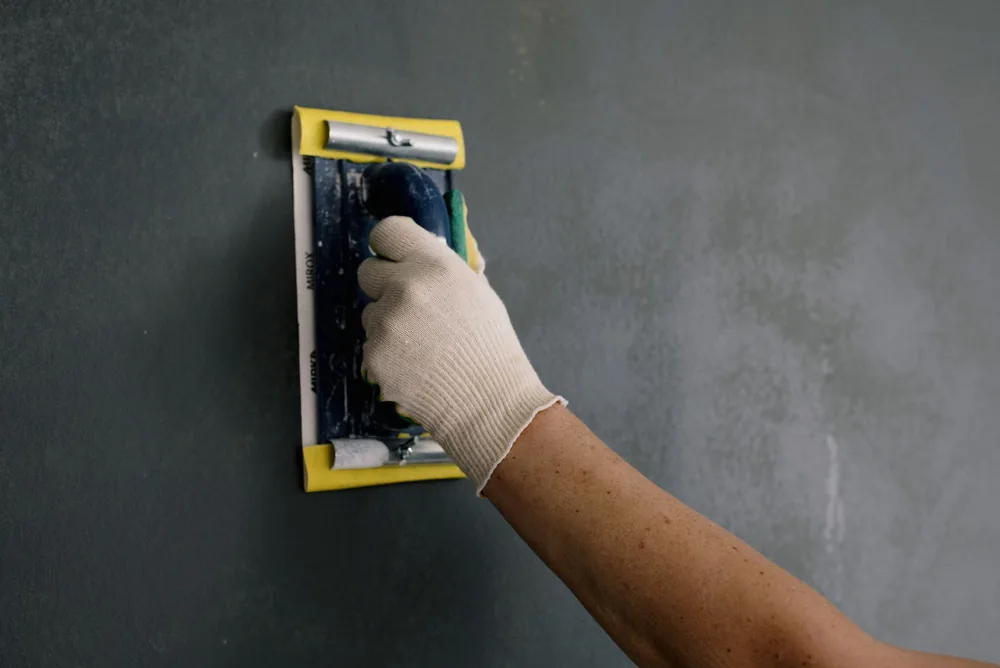 Sanding a repaired wall before painting